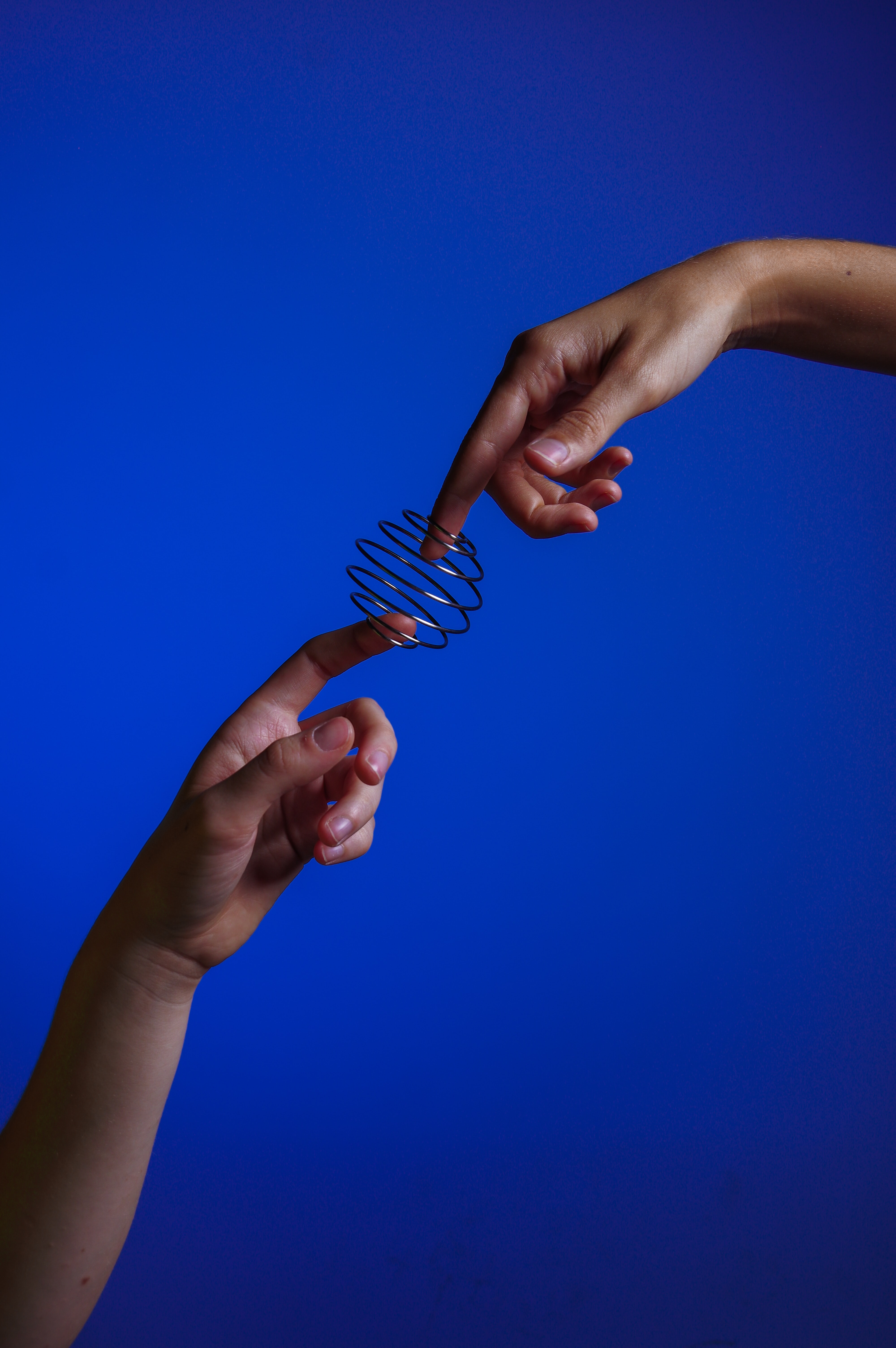 Fingers almost touching with spring connectio