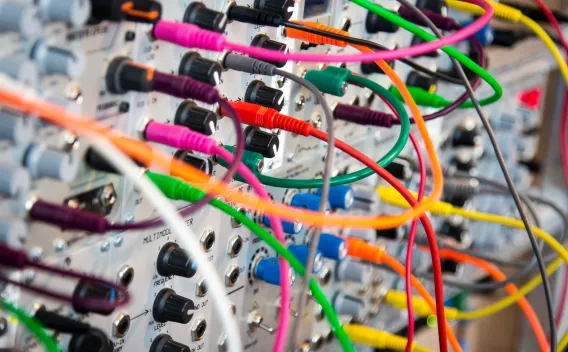 Colorful patch cables in a board with knobs