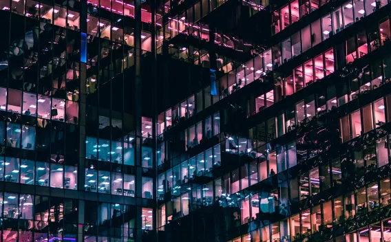 City buildings with multicolored windows at night